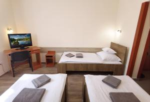 A bed or beds in a room at Kamilla Panzió és Rendezvényház