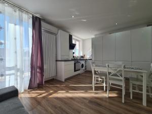 a kitchen with a table and chairs in a room at The Best Apartment in Hunedoara