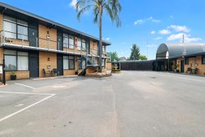 an empty parking lot in front of a building at Avondel Motor Inn in Benalla