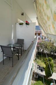 a patio with a table and chairs on a balcony at Nemeapolis 3 apt in Neméa