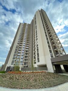 a large apartment building with a landscaping at Arcadia 22 Belgrade Waterfront in Belgrade