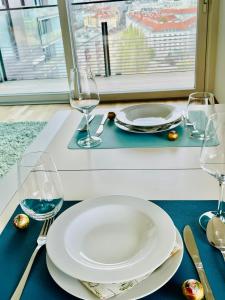 uma mesa com um prato e copos de vinho sobre ele em Royal Swan Skyline, Wien em Viena