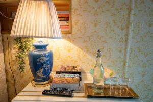 a table with a lamp and a bottle on it at Ryan's Daughter B&B in Thurles