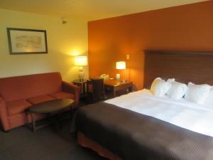 a hotel room with two beds and two lamps at AmericInn by Wyndham Worthington in Worthington