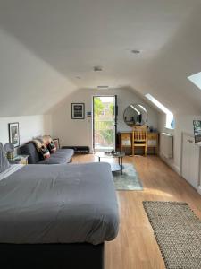 a bedroom with a bed and a living room at The Cherry Tree in Woodbridge