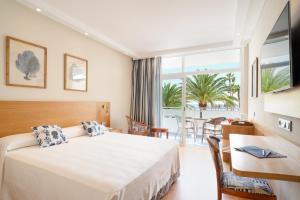 a hotel room with a bed and a balcony at VIK Hotel San Antonio in Puerto del Carmen