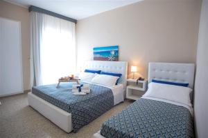 Postel nebo postele na pokoji v ubytování Hotel Lo Scoglio + 25 fotografií