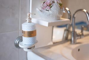 a soap dispenser on a sink in a bathroom at Theofanis Giannoulis apartment in Anemómylos +20 photos