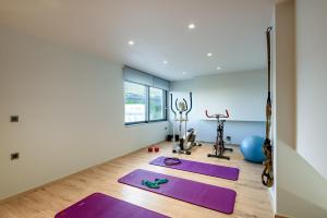 a yoga room with purple mats and exercise equipment at Soleado Villa Chania (rooftop pool) in Chania Town