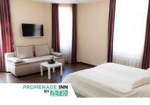 a bedroom with a bed and a couch and a tv at Promenade Inn by ZETTA in Sarajevo