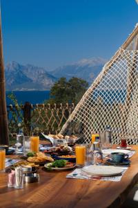 a wooden table with food and drinks on it at Lucky Monkey Hotel in Antalya