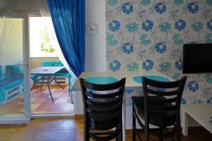 a dining room with a table and two chairs at Apartments Elda in Makarska