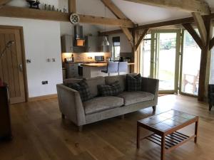 a living room with a couch and a table at Oak Lodge in Tavistock