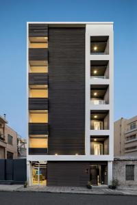 an apartment building with a black facade at Supreme Luxury Suites by Athens Stay in Athens