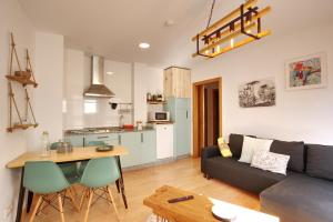 a living room with a couch and a table at VM Apartamentos Turísticos in Santiago de Compostela