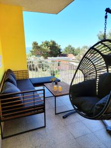 a patio with two chairs and a table at Apartments Dia in Zaostrog +52 photos