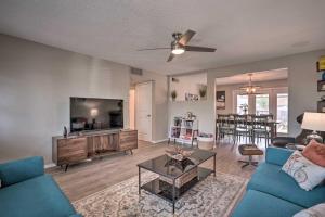 a living room with a couch and a tv at Phoenix Family Home with Pool and Playground! in Phoenix