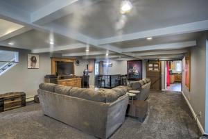 a living room with couches and a flat screen tv at Spacious Sheboygan Home with Grill and Fire Pit! in Sheboygan