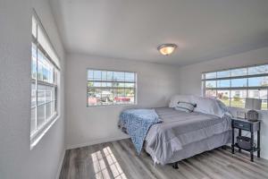 a bedroom with a bed and two windows at Gulf Views and Boat Dock Sunny Hudson Escape! in Hudson