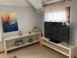 A television and/or entertainment centre at AL CLISI graziosa mansarda