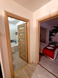 1 dormitorio con cama y baño con espejo. en Apartament Faleza, en Galaţi