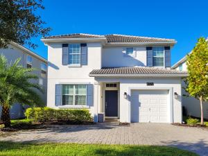 a white house with a garage at 5Br 5Bath Pvt Home BBQ Pool 10min Disney 3077ft in Kissimmee