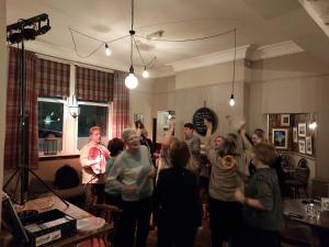 a group of people standing in a room with their hands in the air at Trawden Arms Community Owned Pub in Winewall