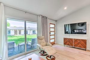 a living room with a chair and a flat screen tv at Remodeled Zilker Townhome with Yard Walk to SXSW! in Austin