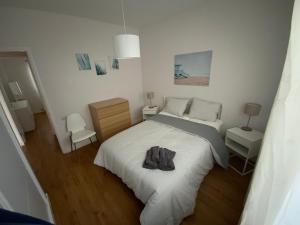 a bedroom with a bed with a pair of shoes on it at La Garita Bay Apartments in La Garita