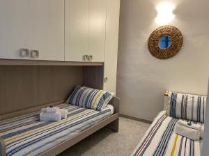 a bedroom with two beds and a mirror on the wall at SEA VIEW APARTMENT in front of the sea in Portovenere