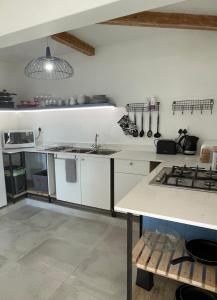 a kitchen with a sink and a stove in it at Whale Rock in Cape Town