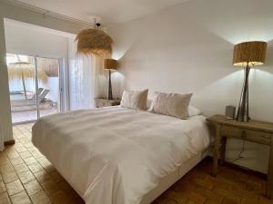 a bedroom with a large white bed with two lamps at Alvor Bela Vista II in Alvor