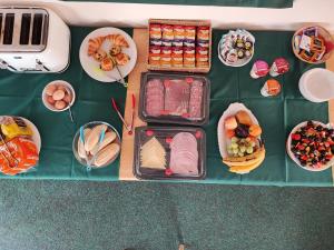 a table topped with plates of food and bowls of food at Honeysuckle Homestead in Dinton +18 photos