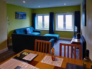 a living room with a table and a couch at Bryn Melyn Apartments in Barmouth