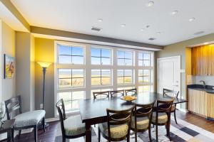 a dining room with a table and chairs at The Sanctuary - Beach and Bay Penthouse B428 in Virginia Beach