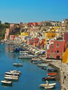 a group of boats are docked in a harbor at La Casa Azzurra in Procida