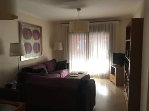 a living room with a purple couch and a window at Javea: Apartment/ flat - Jávea in Jávea
