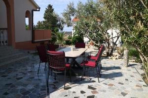 a table and chairs sitting on a patio at Sany&Toyo in Barbat na Rabu