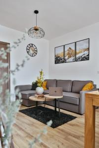 een woonkamer met een bank en een tafel bij Wood Stars Apartment Zlatibor in Zlatibor