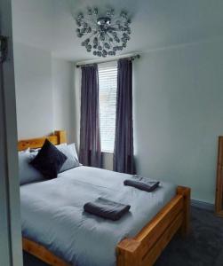 a bedroom with a bed with two towels on it at The Stone House II in Nottingham