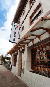 a restaurant with a sign on the side of a building at Cinerama Hostel in San Carlos de Bariloche
