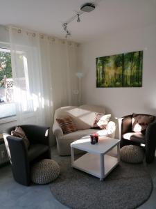 Sala de estar con 2 sofás y mesa de centro en Ferienwohnung Auszeit Parkresidenz, en Hahnenklee-Bockswiese