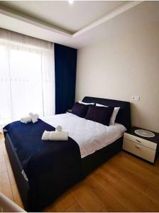 a bedroom with a large bed with towels on it at Garden Grandresidence in Basaksehir