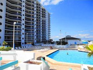 a large swimming pool next to a large building at Surfside Resort #309 in Destin
