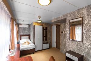 a bedroom with a bed and a window at Botel Vodnik in Prague