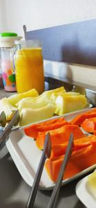 a plate of vegetables and fruit on a table at HOTEL SAYMON in Cafelândia