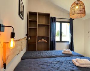 a bedroom with a blue bed and a window at Mazet Brunelly in Paradou +31 photos