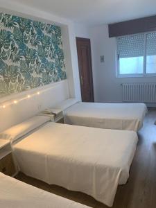 Postel nebo postele na pokoji v ubytování Hostal Linar