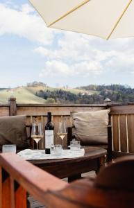 a table with wine glasses and a bottle of wine at Winzer Appartements Kogler in Leutschach