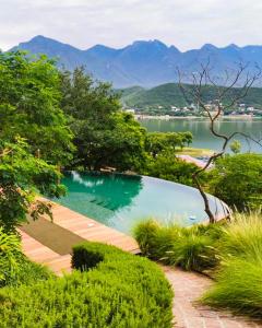 a swimming pool with a view of a body of water at Gamma Monterrey Rincon de Santiago in Santiago